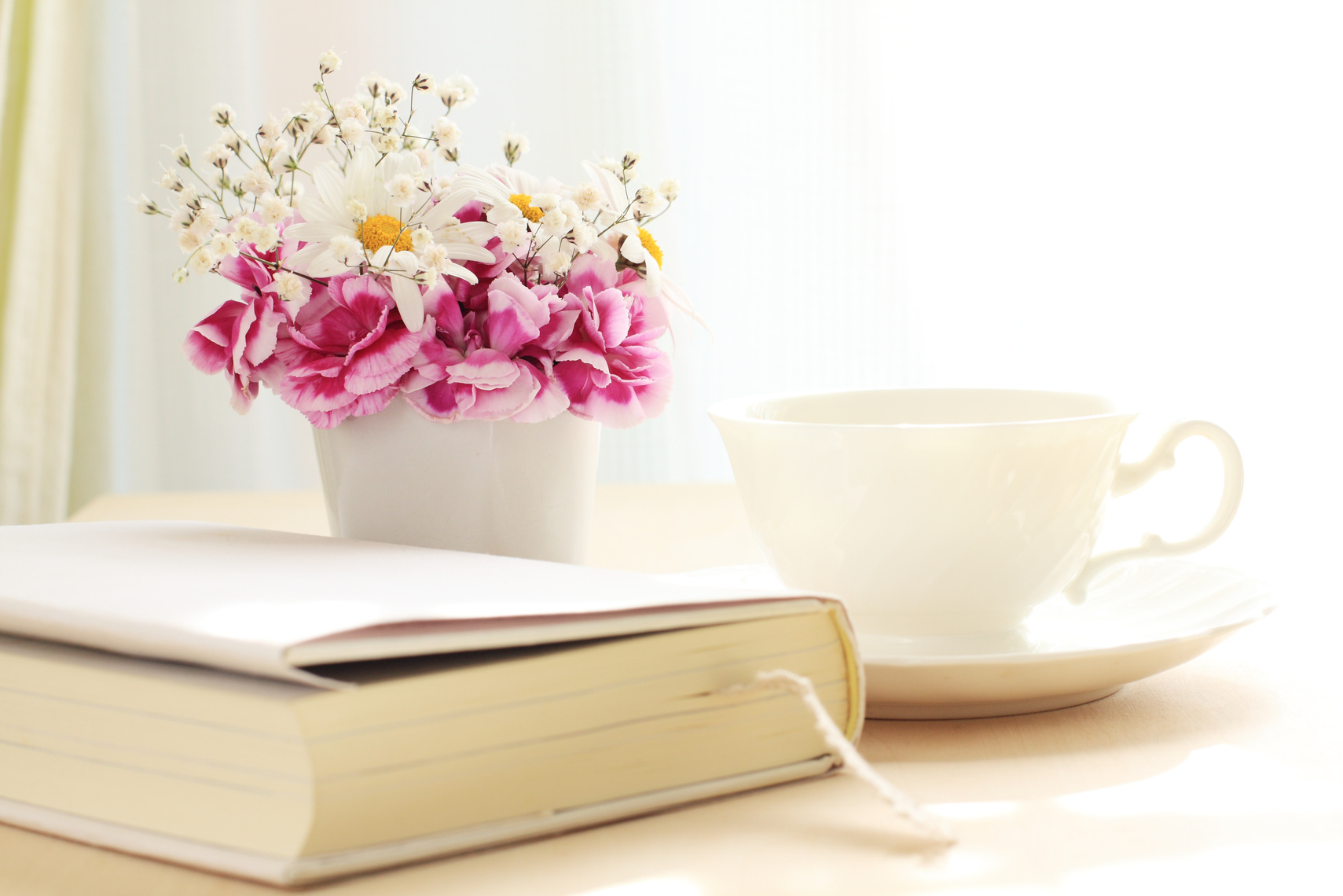 book and flower on table